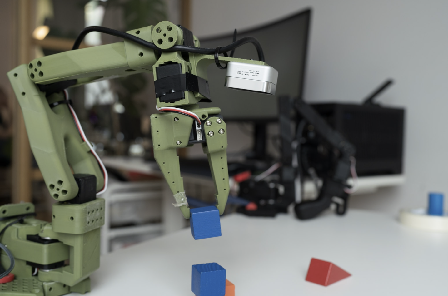 A robot arm stacking cubes on top of each other