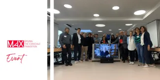 MaX key consortium partners and work-package leaders stand together in the European Commission's review room in Luxembourg.