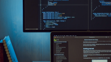 Picture of computers screens displaying programming language 